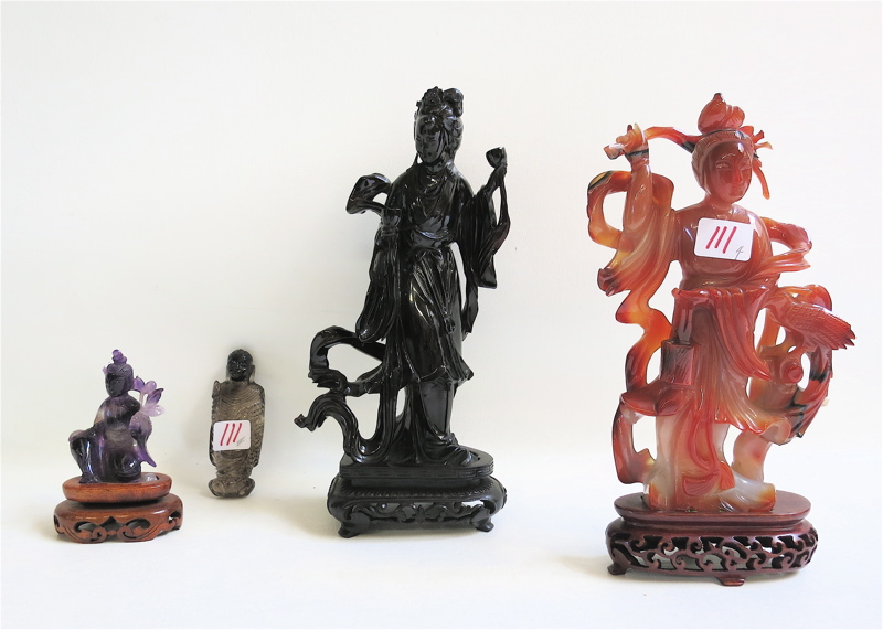 Appraisal: FOUR CHINESE CARVED FIGURES consisting of agate amethyst smoky quartz