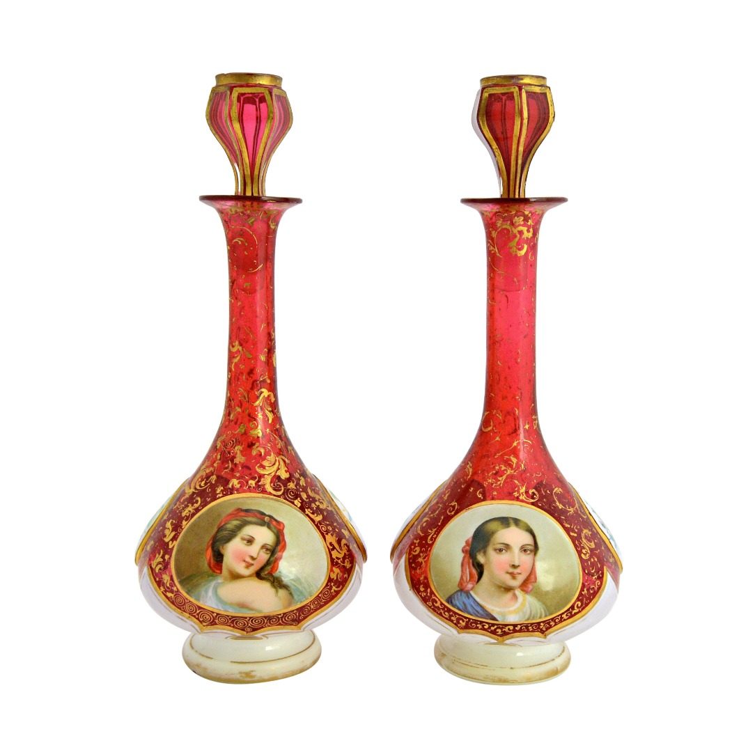 Appraisal: A pair of Bohemian cranberry glass and enamel overlay decanters