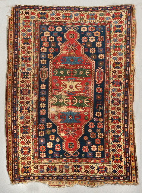 Appraisal: A SHIRVAN BLUE GROUND RUG the central red ground medallion