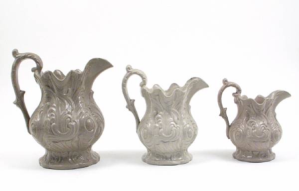 Appraisal: A group of earthenware articles comprising three pitchers height of