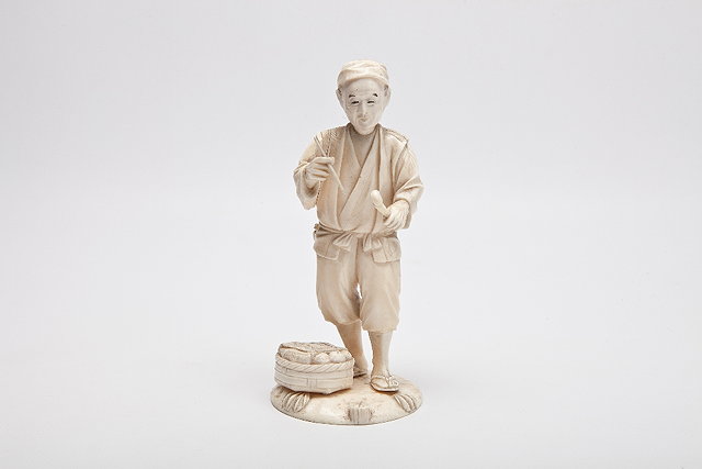 Appraisal: A JAPANESE IVORY OKIMONO OF A STANDING FARMER holding a