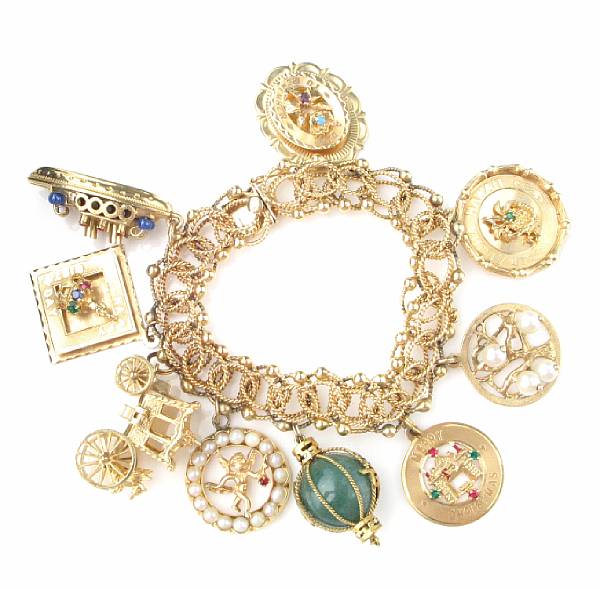 Appraisal: A gold charm bracelet with nine charms length in grams