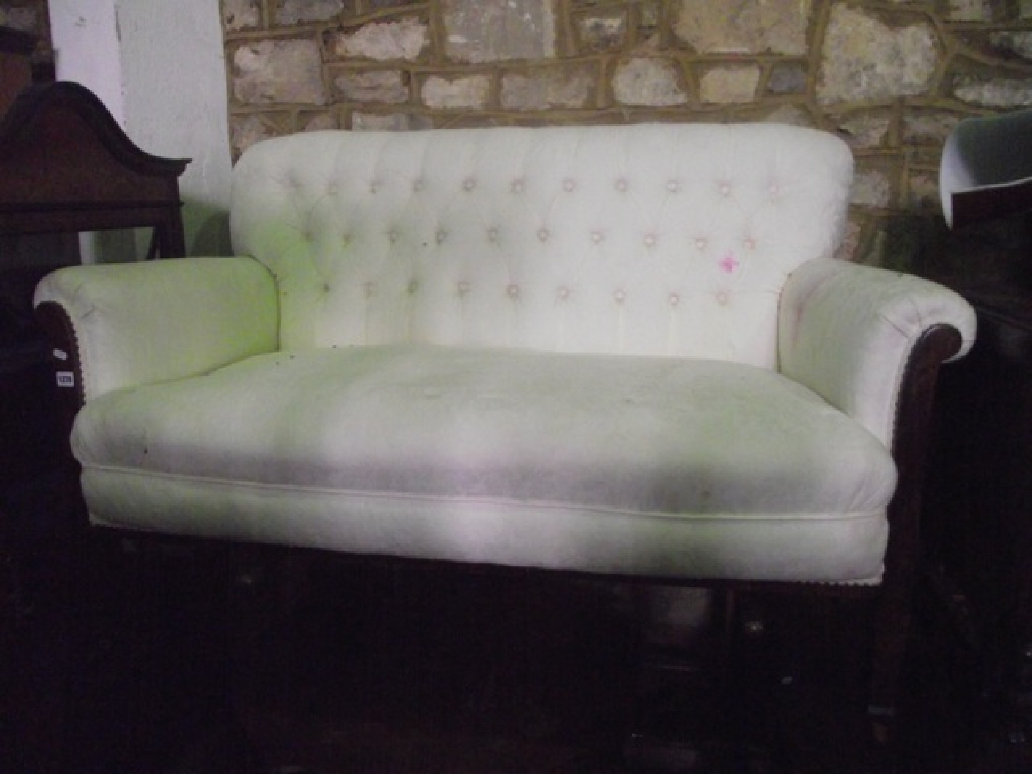 Appraisal: An Edwardian two seat sofa with cream ground floral patterned