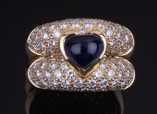 Appraisal: A sapphire and diamond bombe ring by Mouawad the central