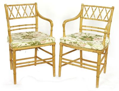 Appraisal: A pair of simulated bamboo open armchairs with rush seats