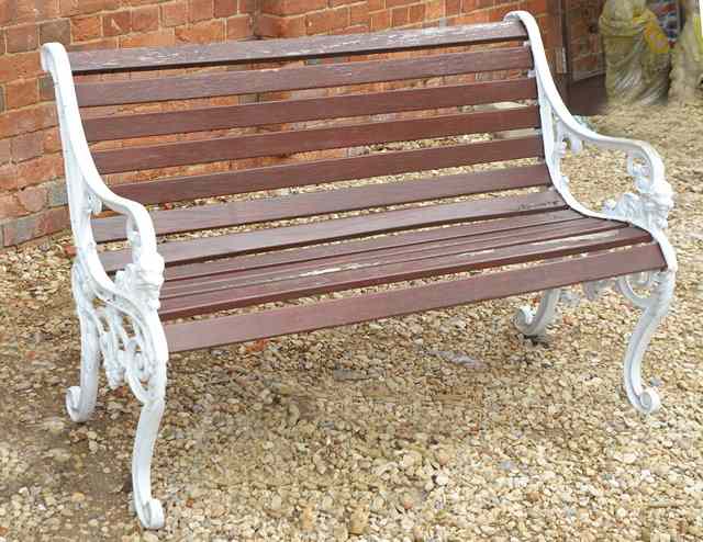 Appraisal: A GARDEN SEAT with white painted cast ends and teak