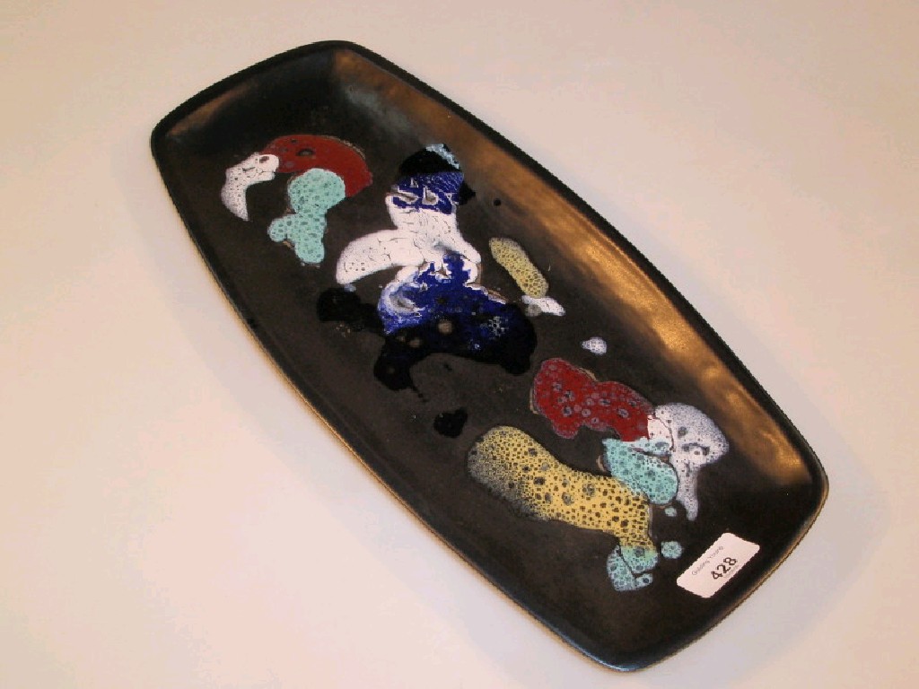 Appraisal: A Newlyn pottery platter of shaped oblong form polychrome enamelled