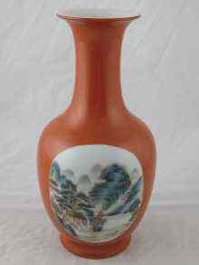 Appraisal: A Chinese ceramic red vase with panels of rural scenes