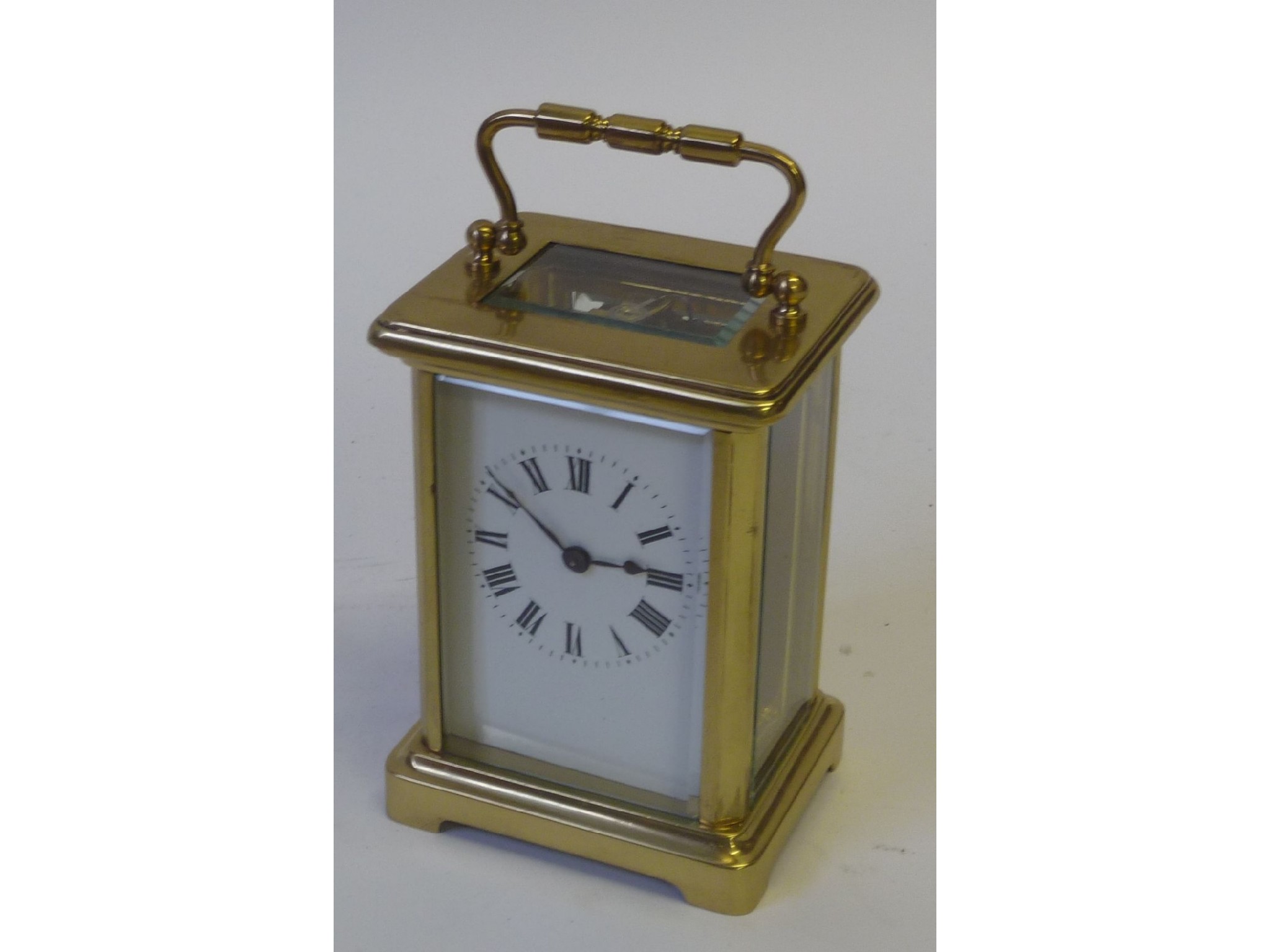 Appraisal: SMALL EARLY TWENTIETH CENTURY FRENCH BRASS CORNICHE CASED TIMEPIECE CARRIAGE