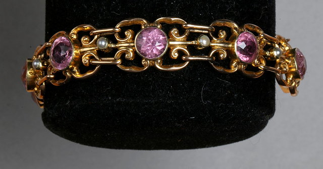 Appraisal: A PINK TOPAZ AND PEARL SET BRACELET nine open scrolled