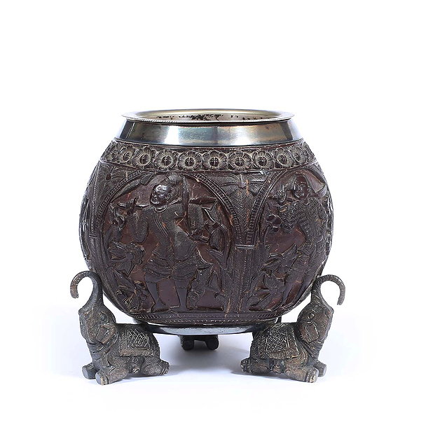 Appraisal: A CARVED COCONUT VESSEL the silver plated lining marked Madras