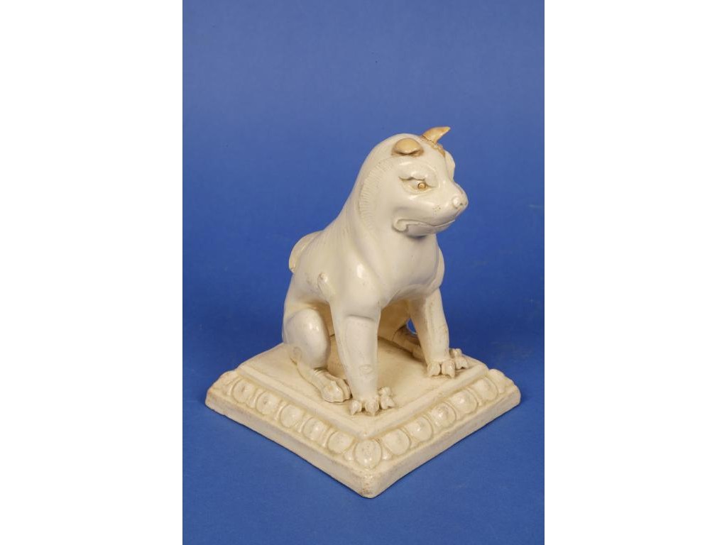 Appraisal: A RARE CHINESE WHITE-GLAZED MYTHICAL DOG seated on its haunches