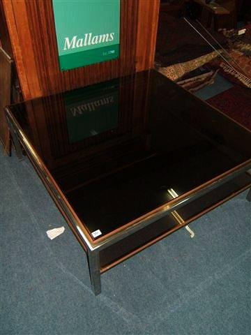 Appraisal: A late th Century chrome and glass coffee table the