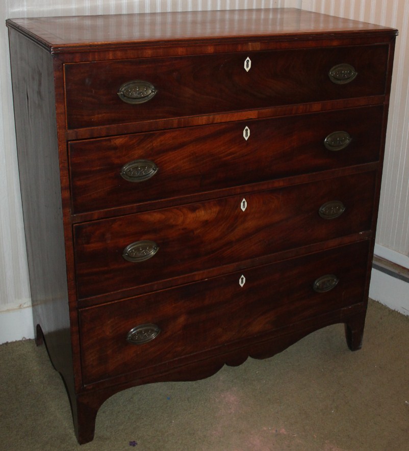 Appraisal: A George III flamed mahogany chest of four graduated drawers