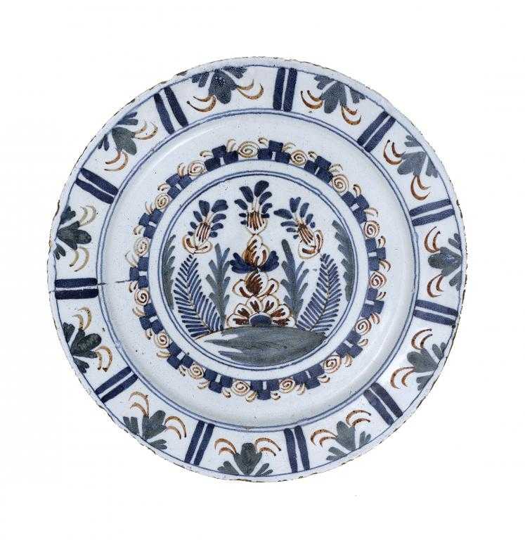 Appraisal: AN ENGLISH DELFTWARE DISH PROBABLY BRISTOL painted in blue-red-green with