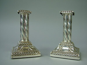 Appraisal: A pair of Victorian silver candlesticks removable sconces over twisted