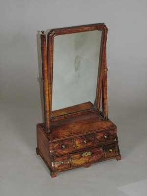 Appraisal: A walnut dressing table mirror early th century the shaped