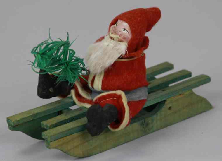 Appraisal: SANTA ON SLEIGH CANDY CONTAINER Germany composition head Santa on