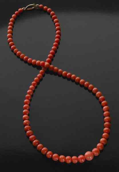 Appraisal: Chinese carved red coral necklace on a gold chain International