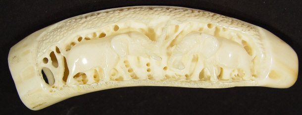 Appraisal: Ivory tusk carved in relief with a panel of elephants