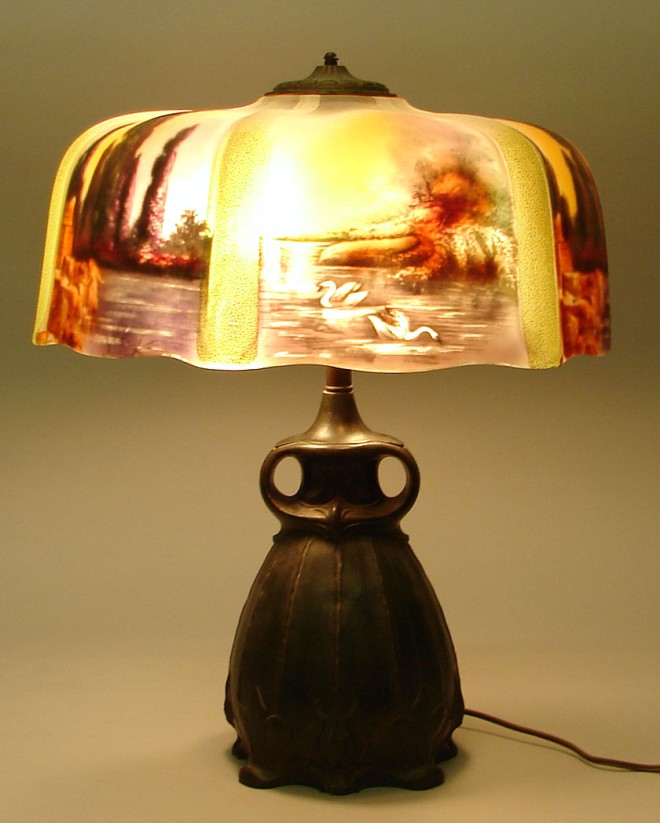 Appraisal: Lamp features Grueby style base with reverse painted scenic shade