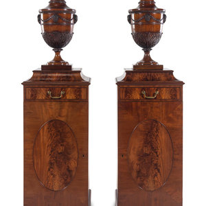 Appraisal: A Pair of Edwardian Style Mahogany Cutlery Urns on Pedestals