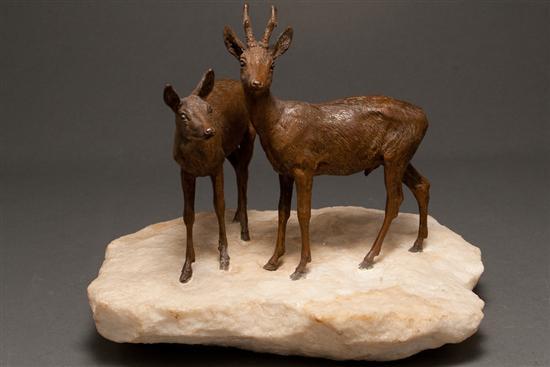 Appraisal: Patinated bronze figural group of two deer mounted on quartz