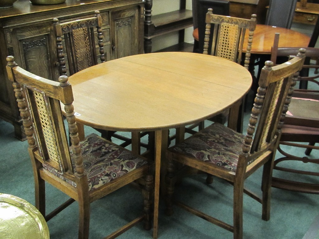 Appraisal: Oak drop leaf dining table with four cane back chairs