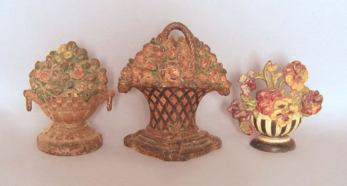 Appraisal: Three cast iron flower basket door stops ca h h