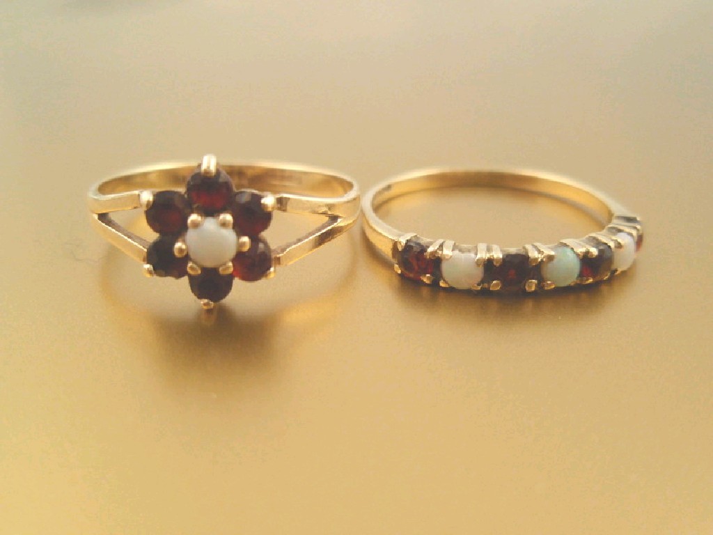 Appraisal: Two garnet and opal set dress rings