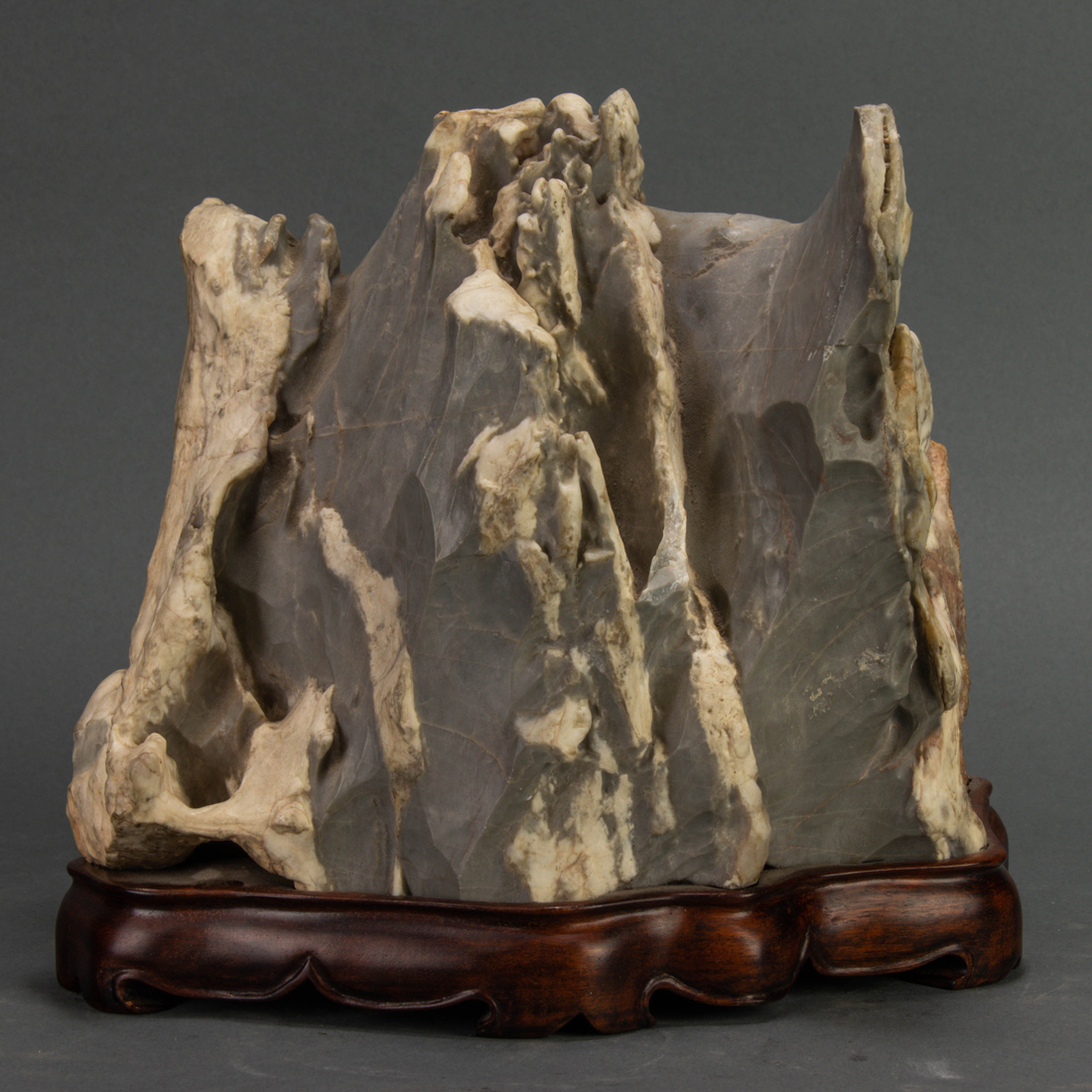 Appraisal: Chinese gray and beige limestone scholar's rock displaying three peaks