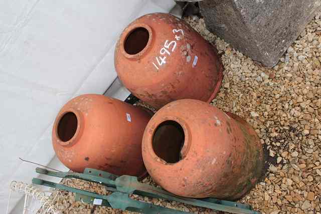 Appraisal: THREE TERRACOTTA RHUBARB FORCERS of bell shape high