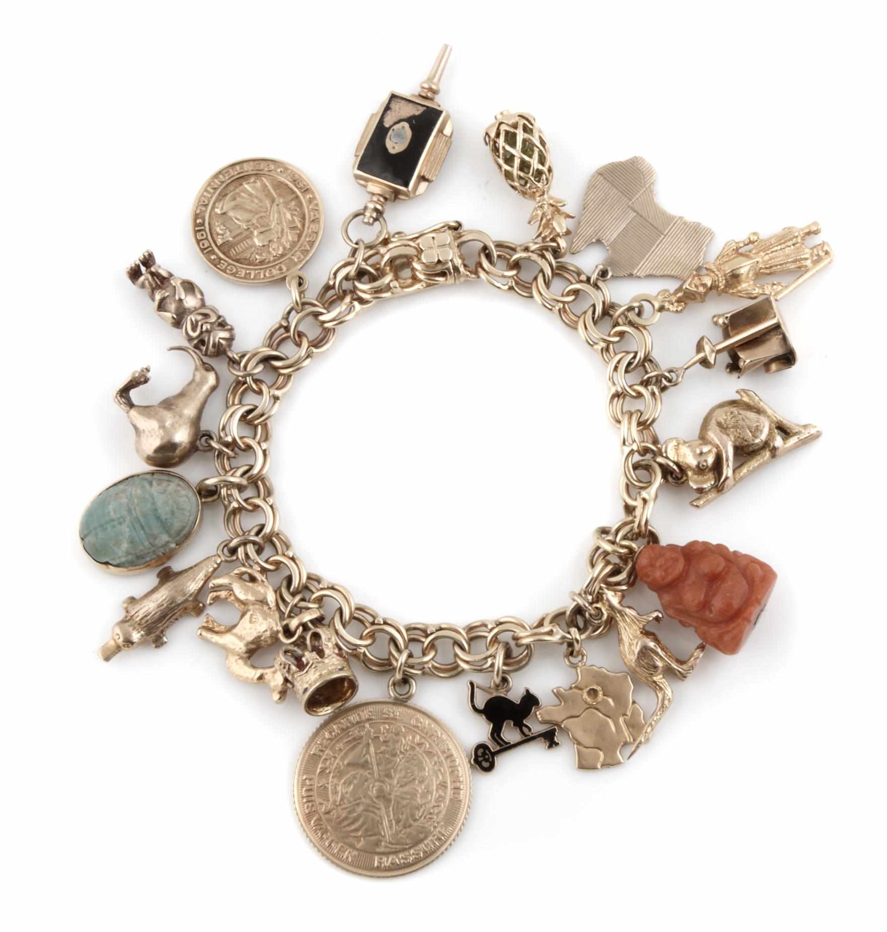 Appraisal: Property of various owners A gold charm bracelet with stone