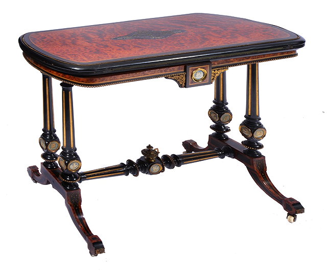 Appraisal: A VICTORIAN AMBOYNA AND EBONISED CARD TABLE with fold over