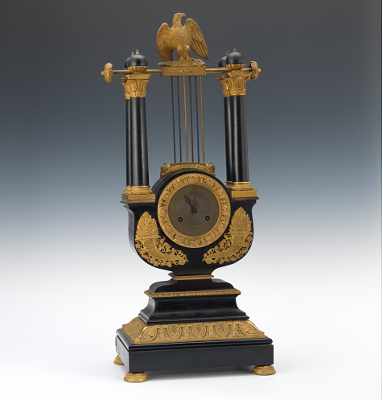 Appraisal: A French Empire Lyre Clock ca Ebony veneered clock with