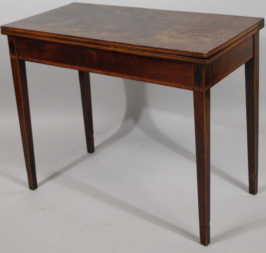 Appraisal: A George III mahogany fold-over tea table the plain rectangular