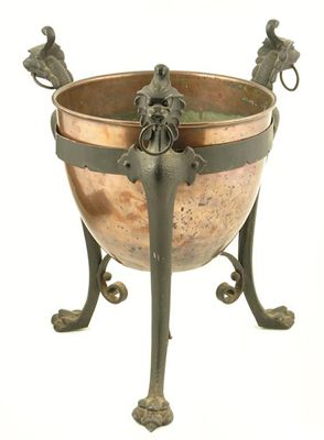 Appraisal: A copper and cast iron jardiniere the lift-out liner supported