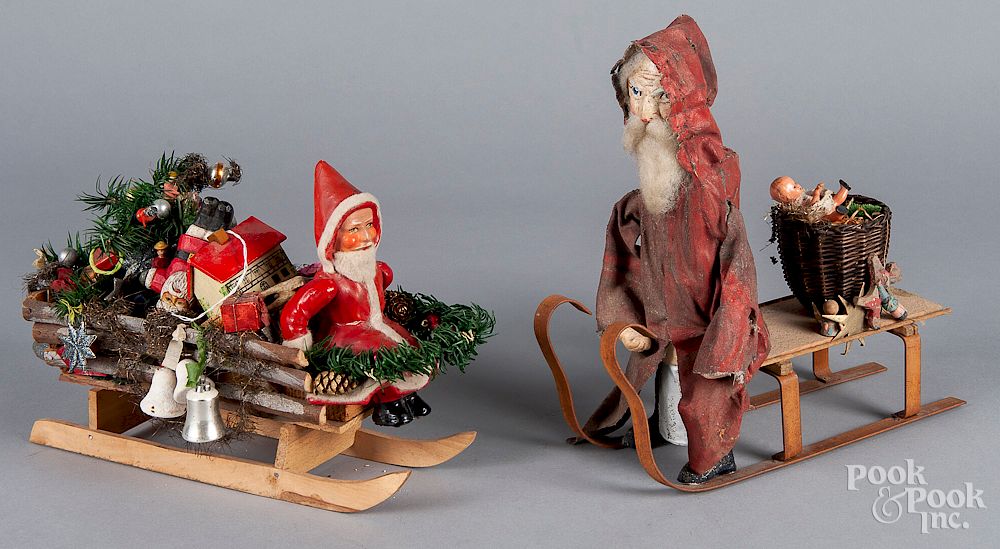 Appraisal: Two Santa Claus in sleigh toys Two Santa Claus in