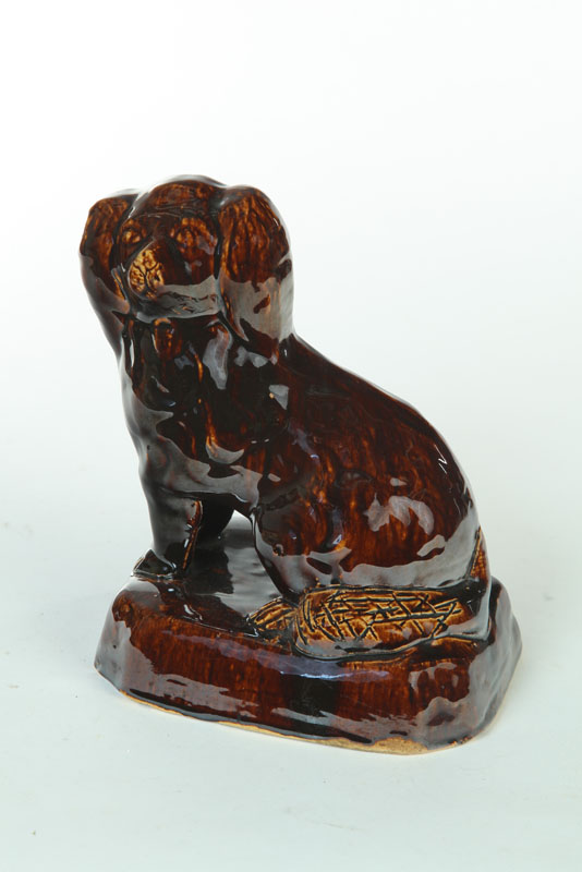 Appraisal: ROCKINGHAM DOG American or English th century Seated spaniel ''h