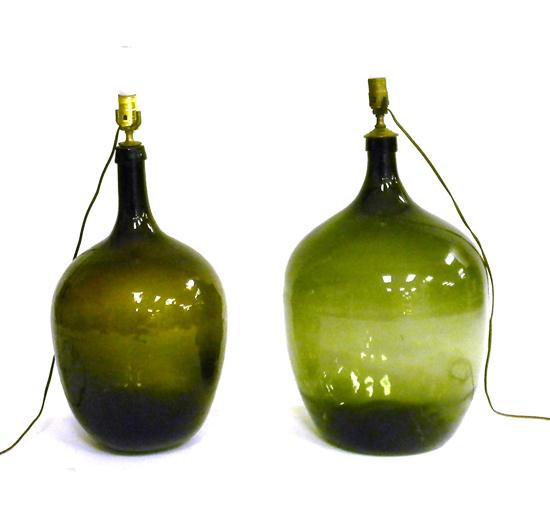 Appraisal: Two bulbous green glass demijohn bottles converted into lighting fixtures