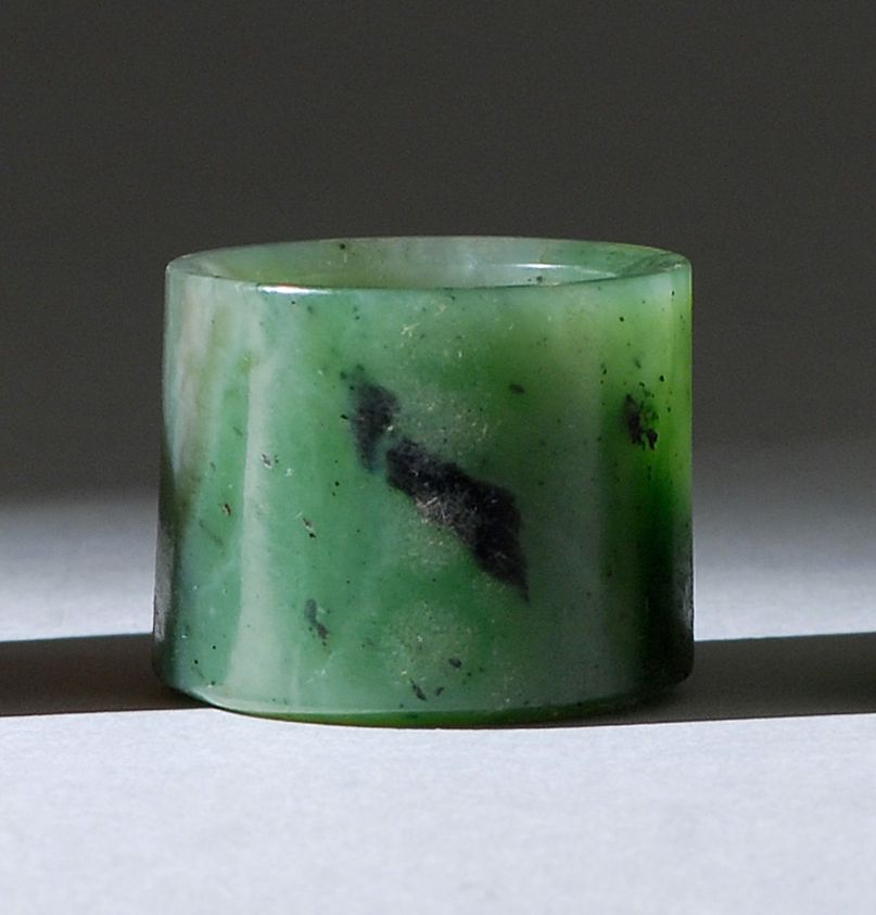 Appraisal: GREEN JADE ARCHER'S RING Circa In cylinder form with black