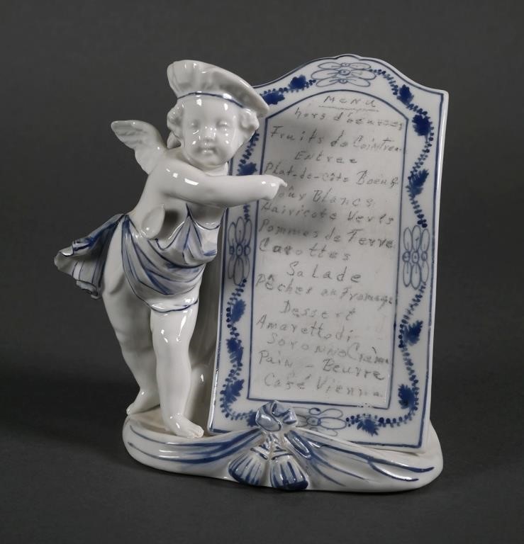 Appraisal: Antique porcelain figurine of a cherub dressed as a baker