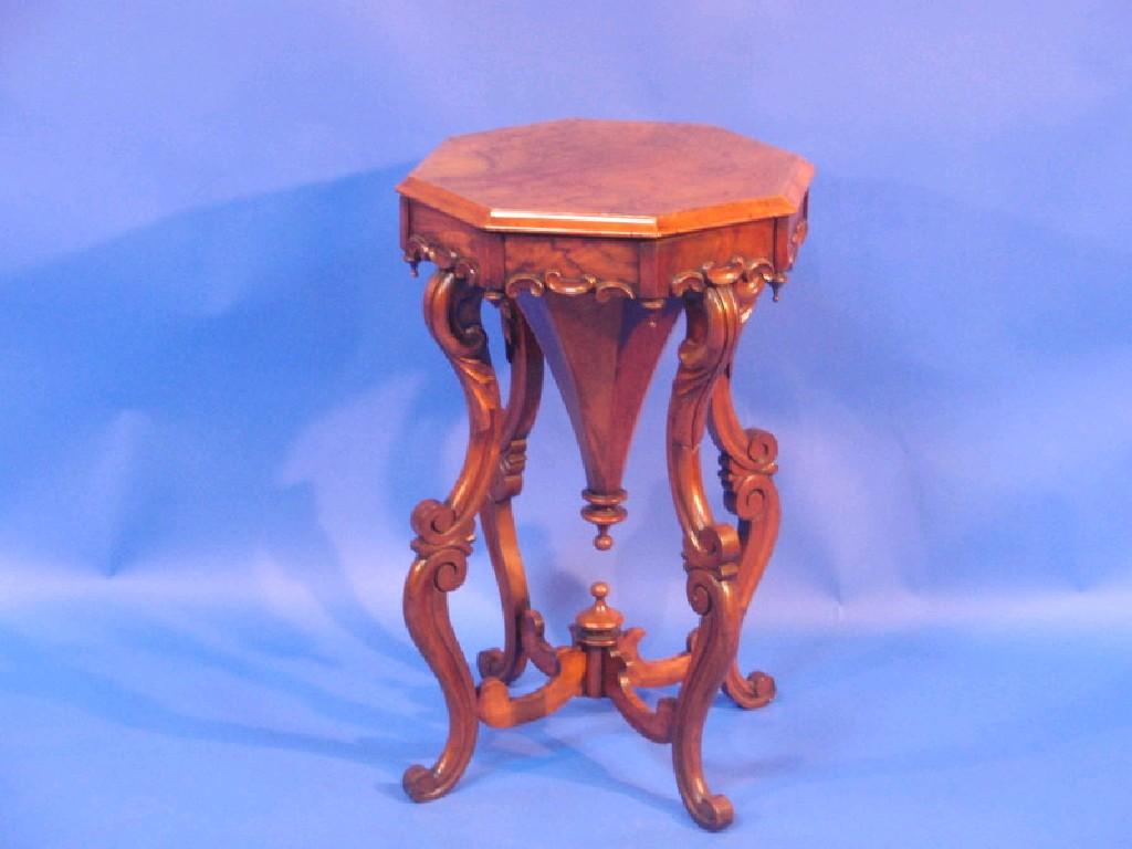 Appraisal: A Victorian walnut sewing table the octagonal hinged lid revealing