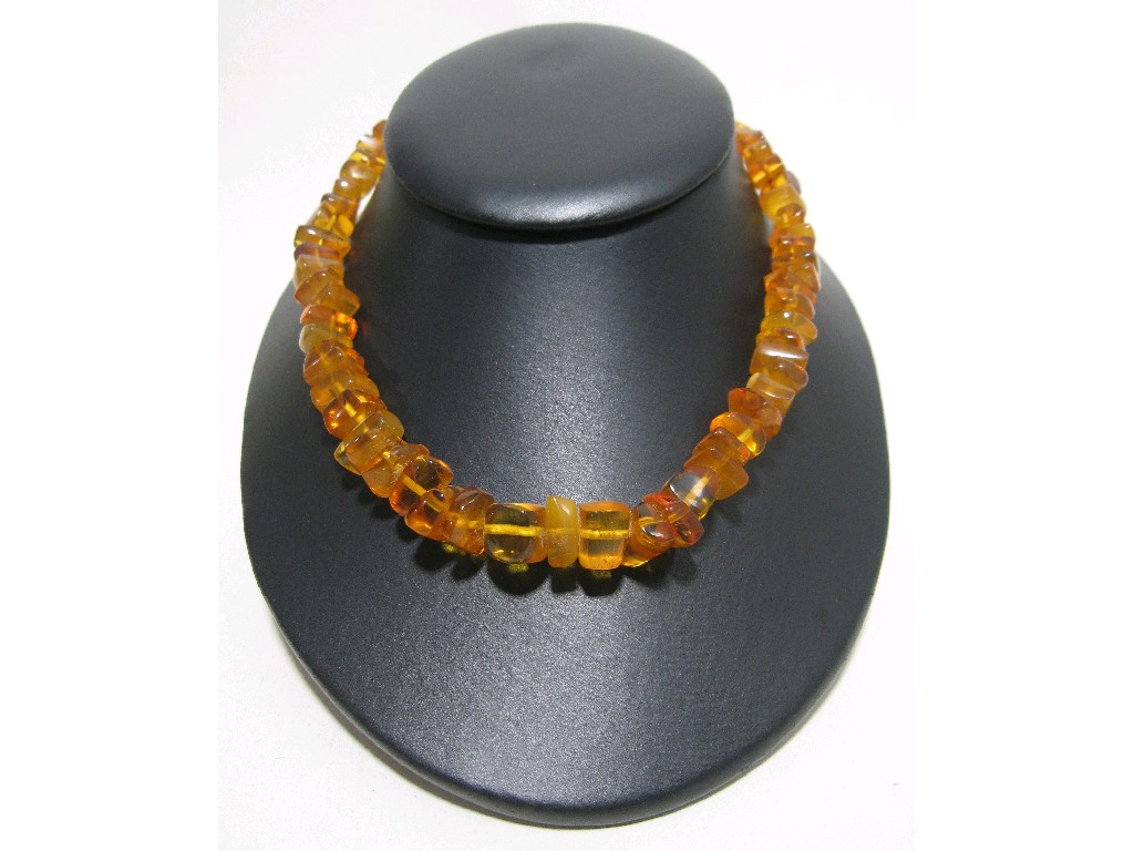 Appraisal: String of yellow amber beads with ct gold clasp