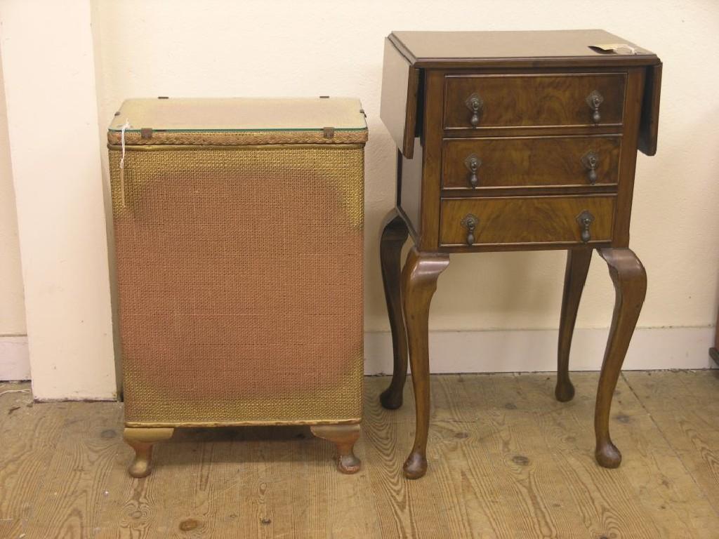 Appraisal: A walnut-veneered drop-leaf bedside chest three drawers with drop handles