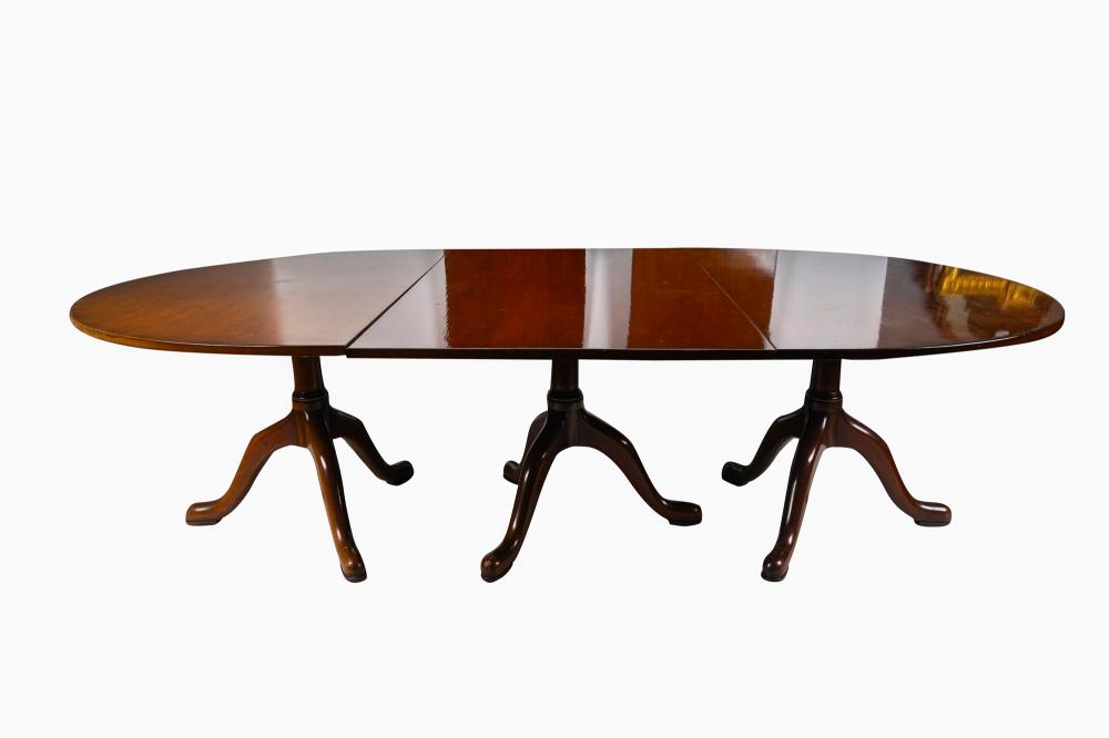 Appraisal: TRIPLE PEDESTAL MAHOGANY DINING TABLEwith three leaves Provenance The Estate