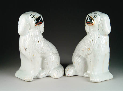 Appraisal: PAIR OF STAFFORDSHIRE DOG FIGURES White with black trim Spaniels