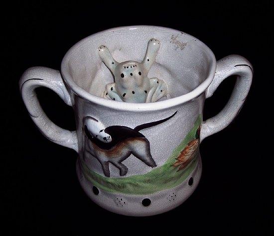 Appraisal: A Staffordshire two-handled frog mug the exterior with hound and