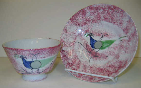 Appraisal: ENGLISH SPATTERWARE Red spatter Peafowl handless cup and saucer decorated