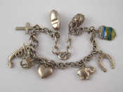 Appraisal: A white metal tests silver charm bracelet approx cm long